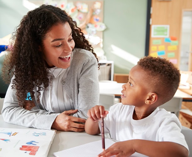 Teacher Tutoring Student Classroom