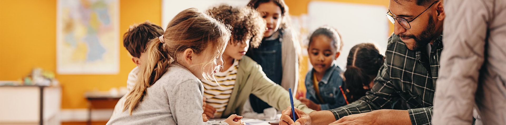 Elementary Teacher Helping Students Classroom