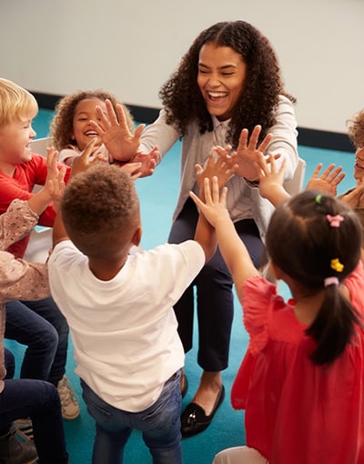 Preschool Teacher Playing With Children