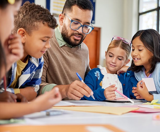 Teacher Guiding Elementary Students Classroom