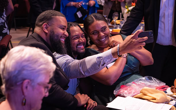 Gala Guests Taking Selfie At Dinner Table